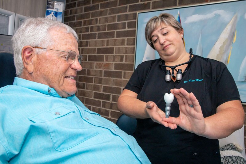 dr kari mann showing implant to alan